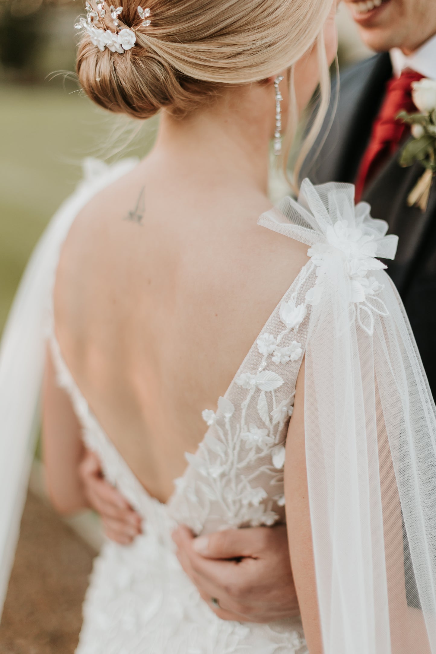 Back view of bride wearing Saige gown with low V-backline and 3D lace