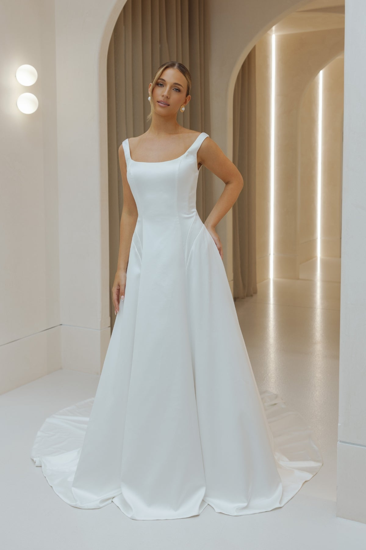 Satin A-line sheath wedding gown with square neckline and straps.