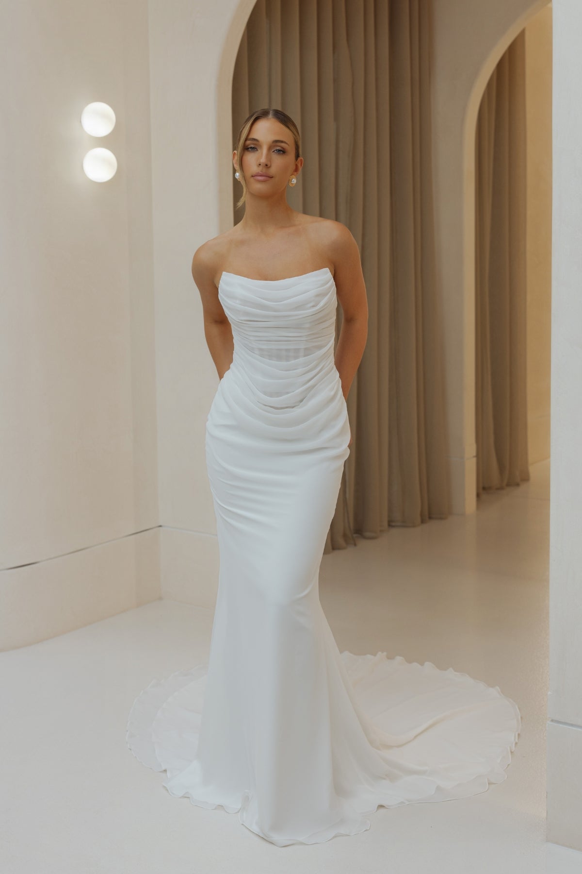 Fitted Bridal gown in draped chiffon, featuring cat-eye neckline