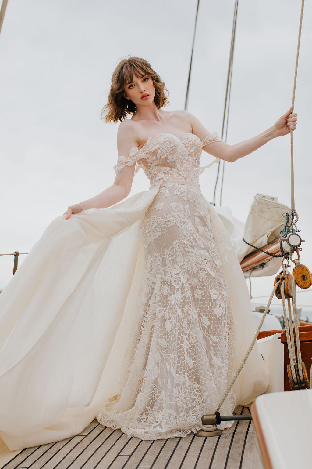 Side view of Orla overskirt that attaches at the waist and flares out from the sides of the gown