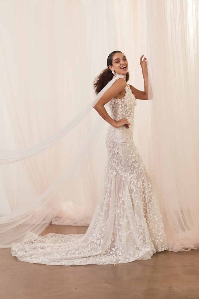 Detachable Saige Wingsdrape behind model wearing Saige wedding gown