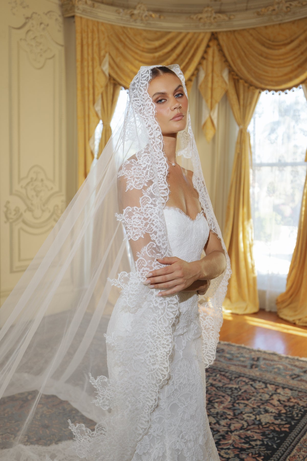fitted lace wedding gown with sweetheart neckline and scalloped train