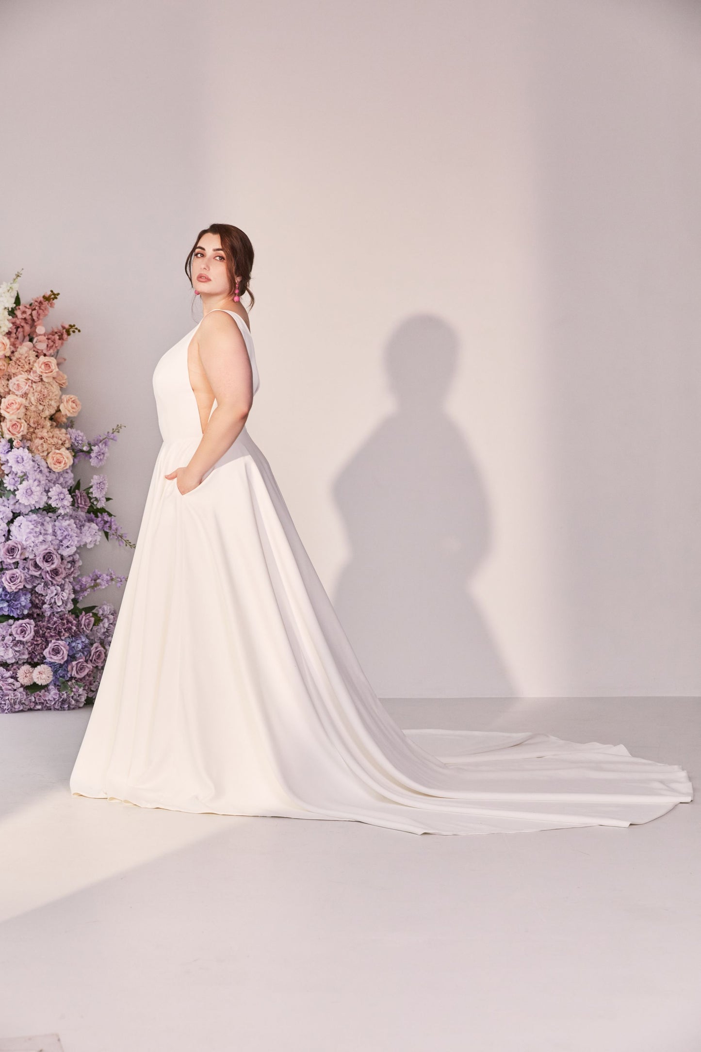 Wedding gown in ivory with illusion mesh v-neck and v sides. A-line skirt with pockets.