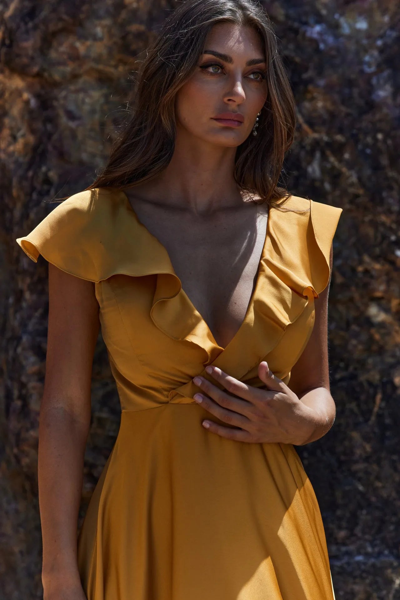 Close up of petal bridesmaid gown in honey colour satin with cross over front and frill