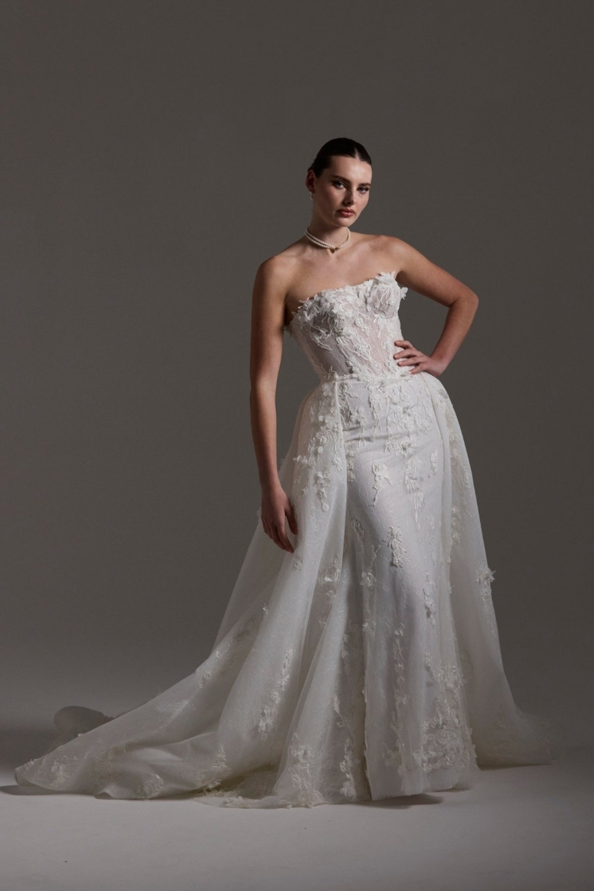Fitted bridal gown with floral lace and strapless neckline