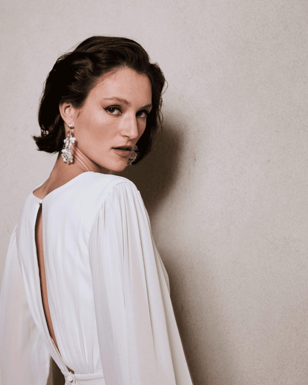 White clay flowers on silver hoop earrings hanging from diamante stud