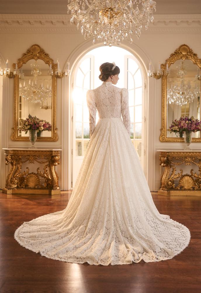 Back view of Tatyana dress in full lace with a-line skirt and dramatic train. Completely covered to top of the neck.