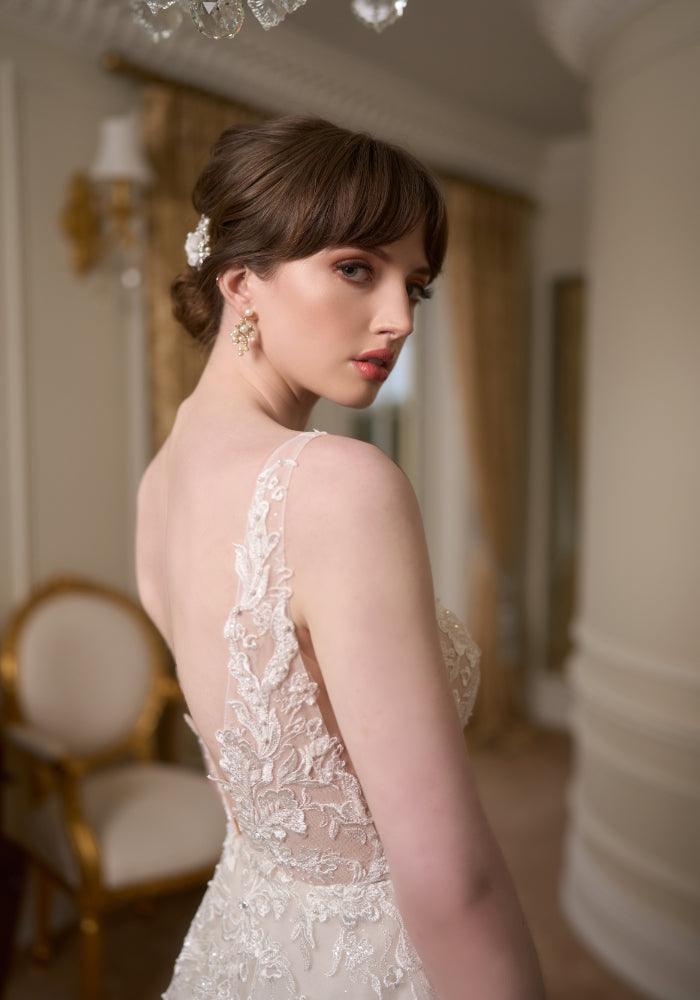 Back view of Tilly bodice with leafy embroidered lace stitched with pearls and beads. Plunging V back that meets at the waist with A-line skirt.