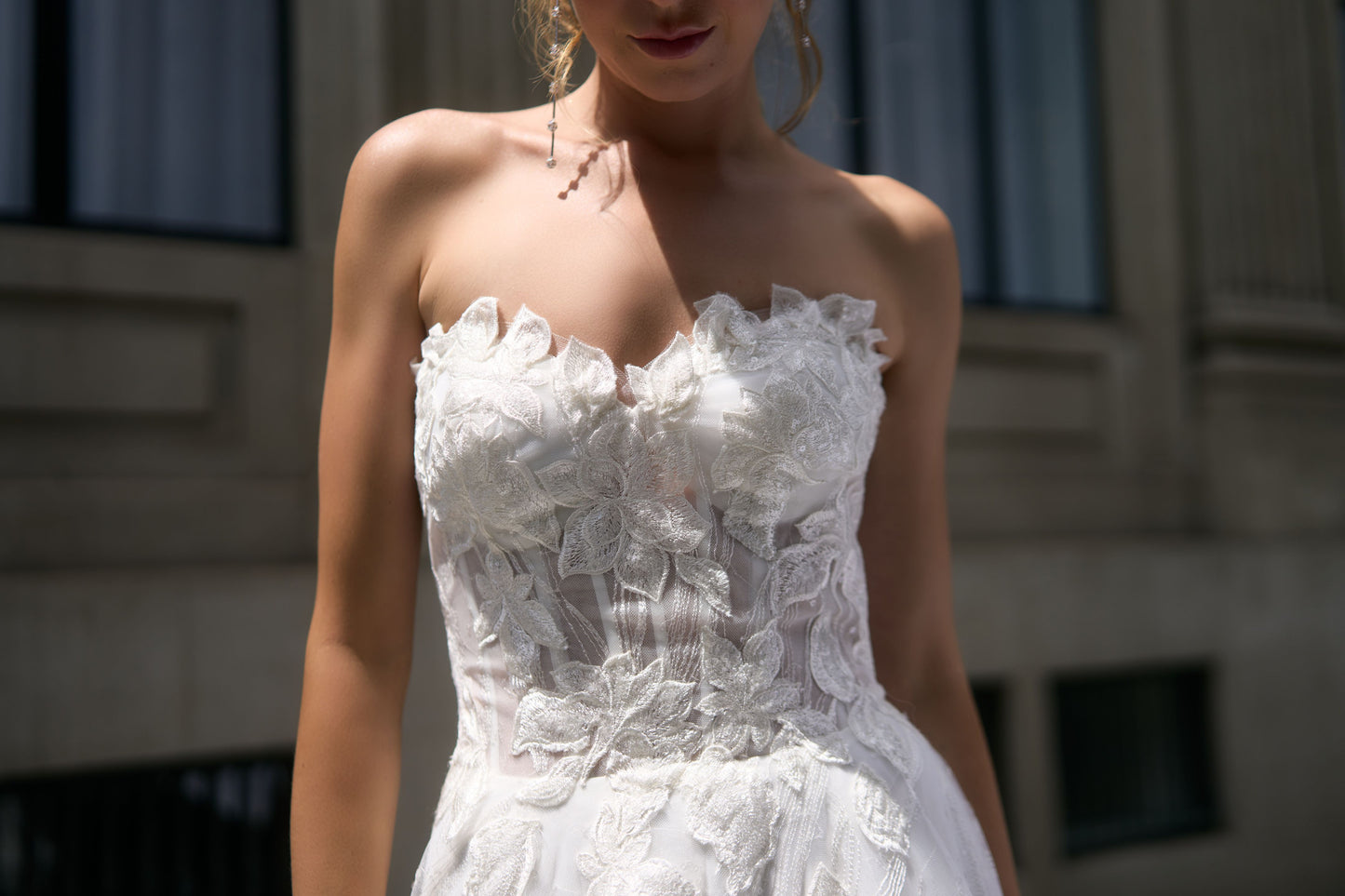 Renee wedding dress with unique A-line silhouette, crafted in floral fabric. Strapless design cinches at the waist for support at the décolletage. Flowy skirt adds lightness and luxury to the dress.