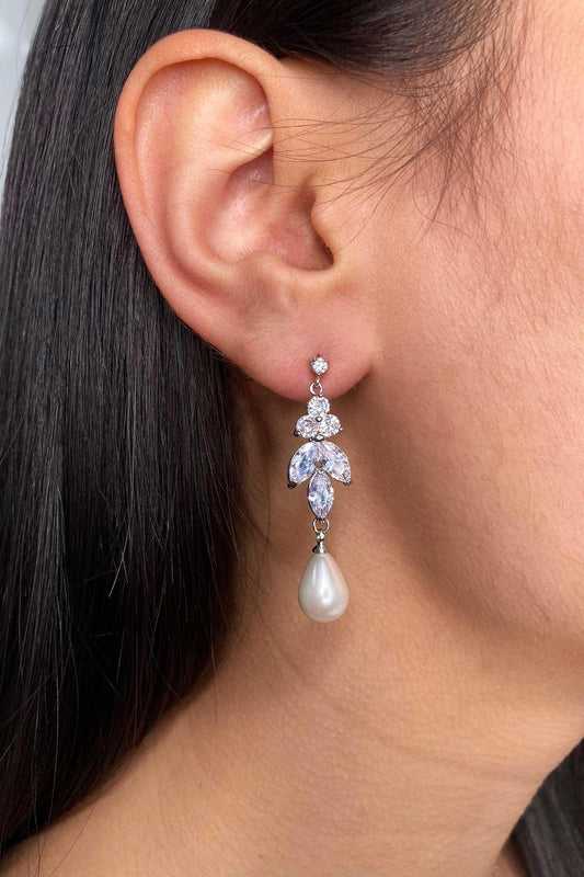 Remy Earrings in a drop of cubic zirconia with a teardrop pearl hanging from the bottom.