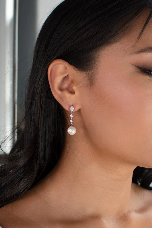Diamante drop earrings with pearl at bottom.