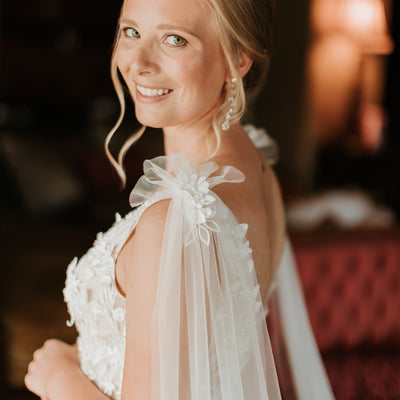 Side angle of bride wearing Saige gown with Saige wings