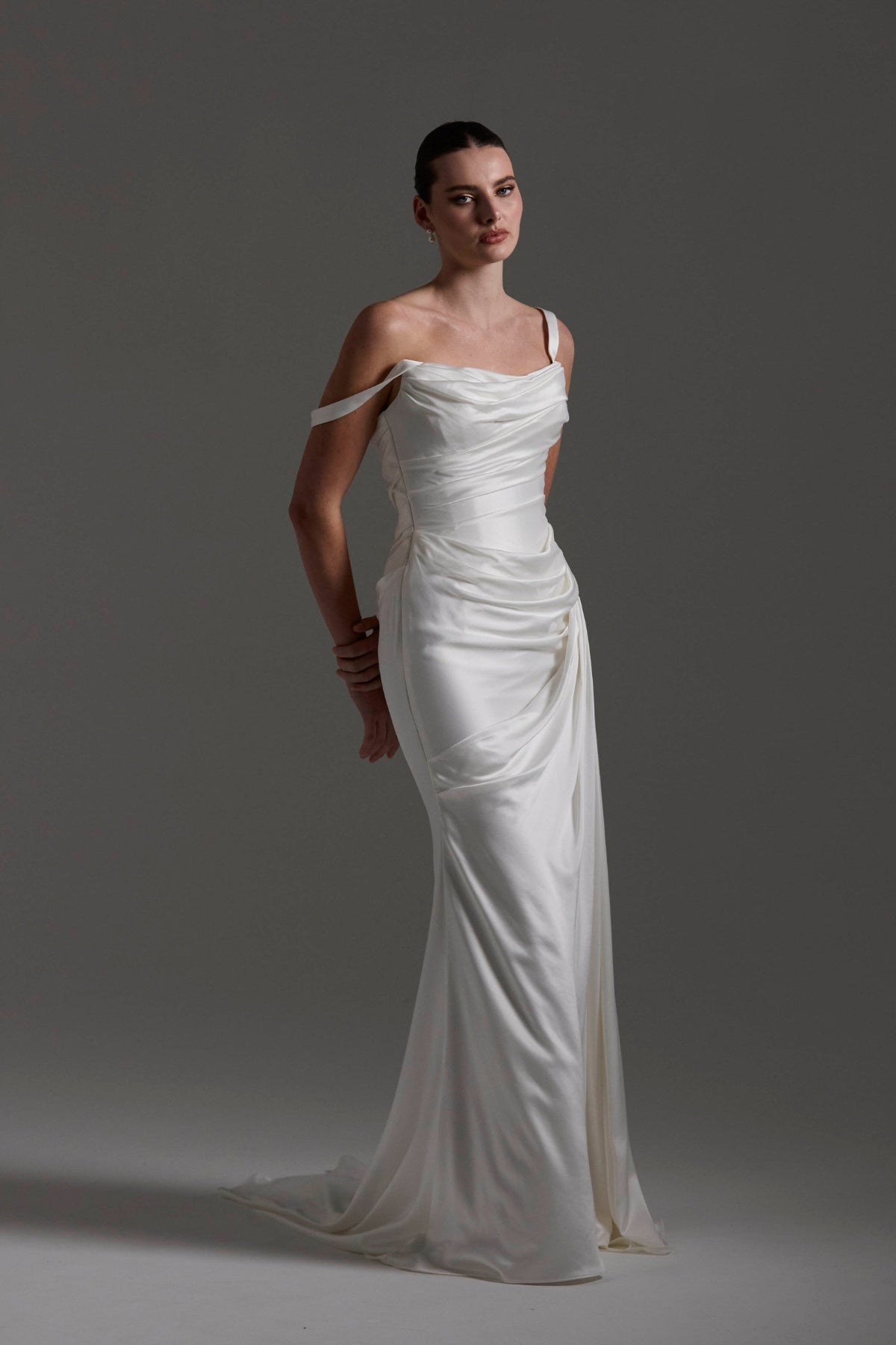 fitted satin wedding dress with pleats across bust and hips. Featuring off the shoulder straps. 