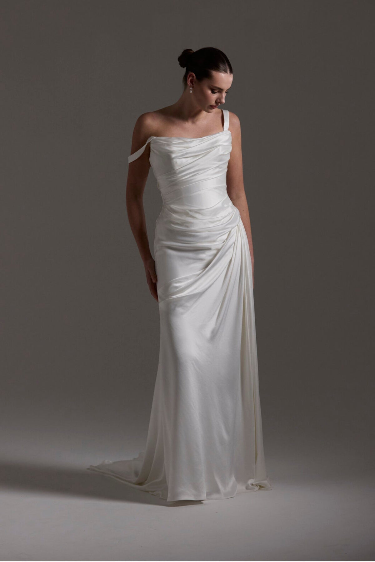 fitted satin wedding dress with pleats across bust and hips. Featuring off the shoulder straps. 