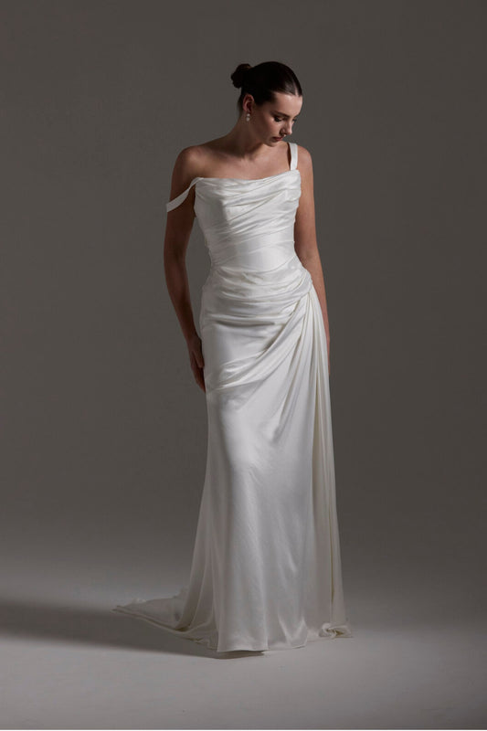 fitted satin wedding dress with pleats across bust and hips. Featuring off the shoulder straps. 