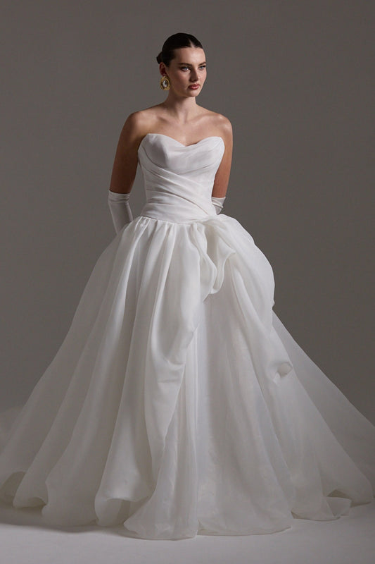 A-line wedding dress crafted in Organza, sweetheart neckline and assymetrical ruffle down the skirt. 