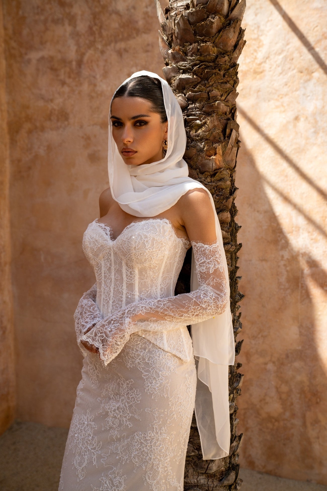 2-piece lace wedding gown, corset top and fitted skirt. paired with fitted sleeves 