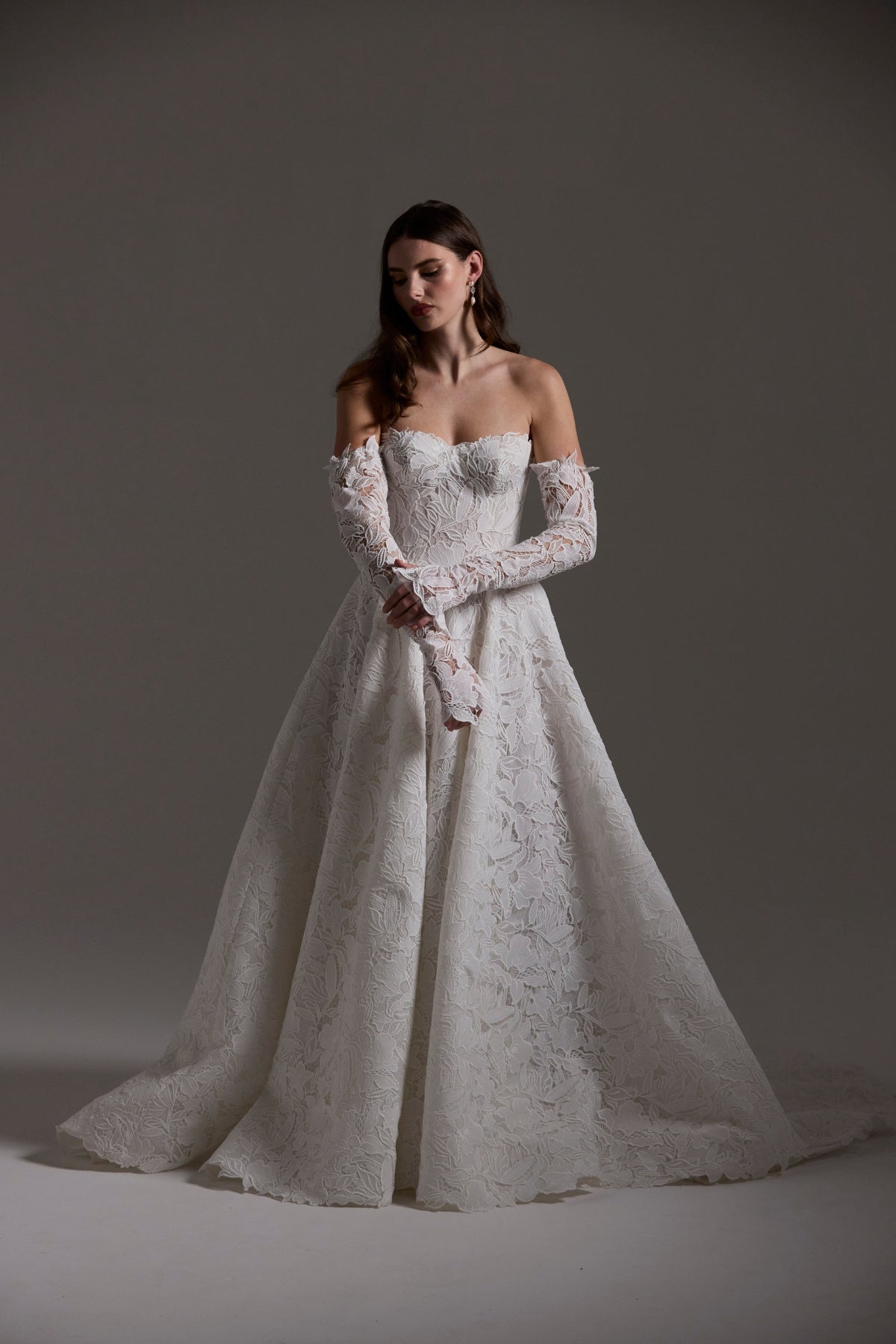 A-line Wedding dress in floral Jacquard fabric with fitted sleeves and a strapless bodice 