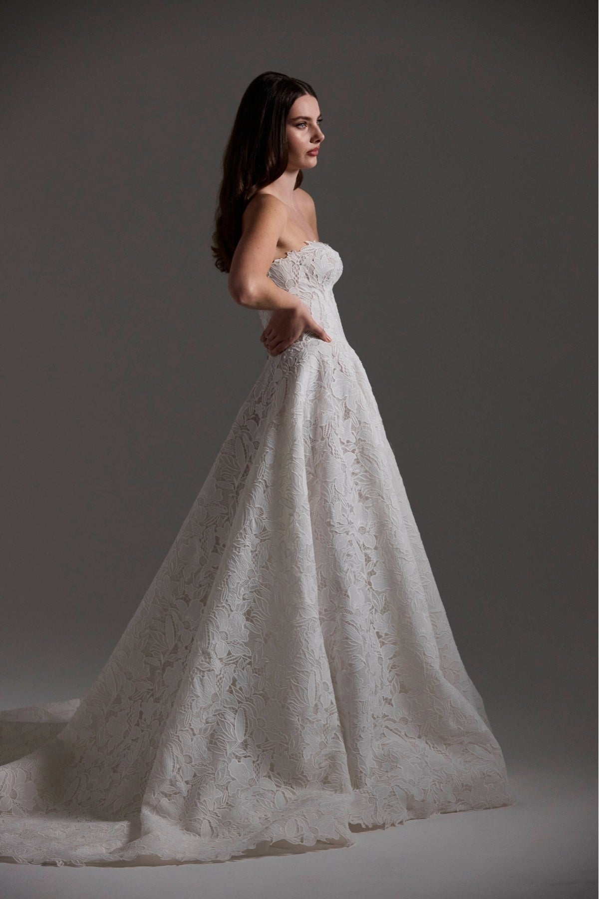 A-line Wedding dress in floral Jacquard fabric with fitted sleeves and a strapless bodice 