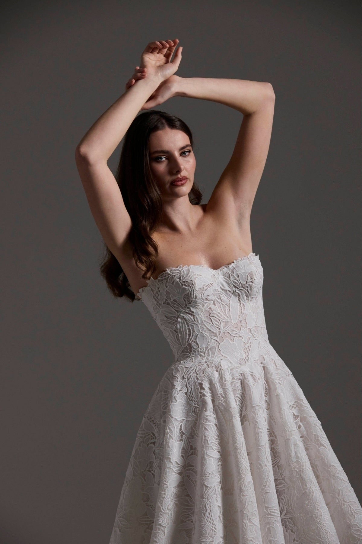 A-line Wedding dress in floral Jacquard fabric with fitted sleeves and a strapless bodice 