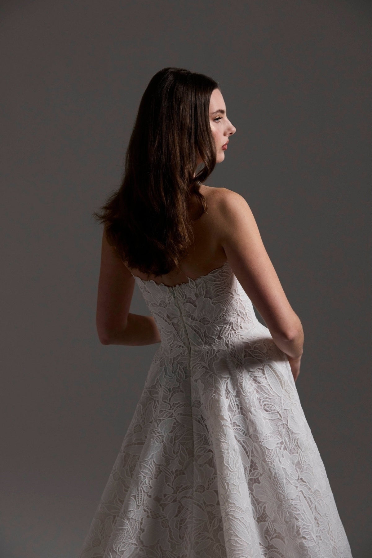 A-line Wedding dress in floral Jacquard fabric with fitted sleeves and a strapless bodice 