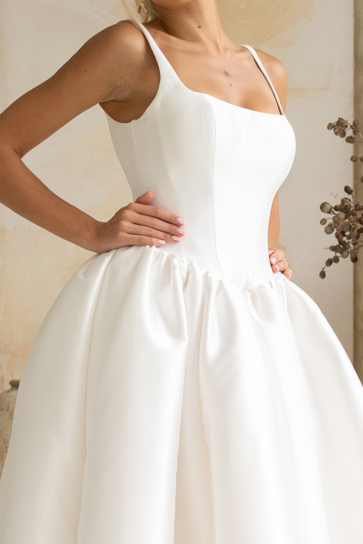 Dramatic A-line wedding gown featuring a squared neckline with straps. subtle basque waist with ruching all around waistline. chapel train. 