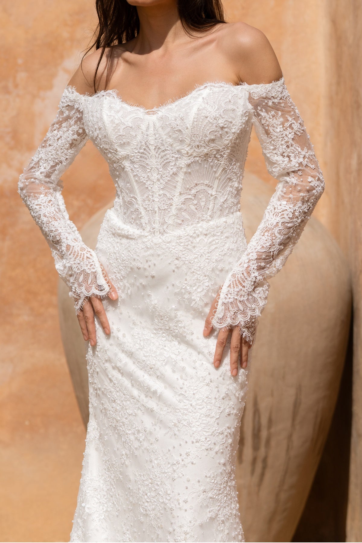 Fitted wedding gown in beaded lace, with sleeves. 