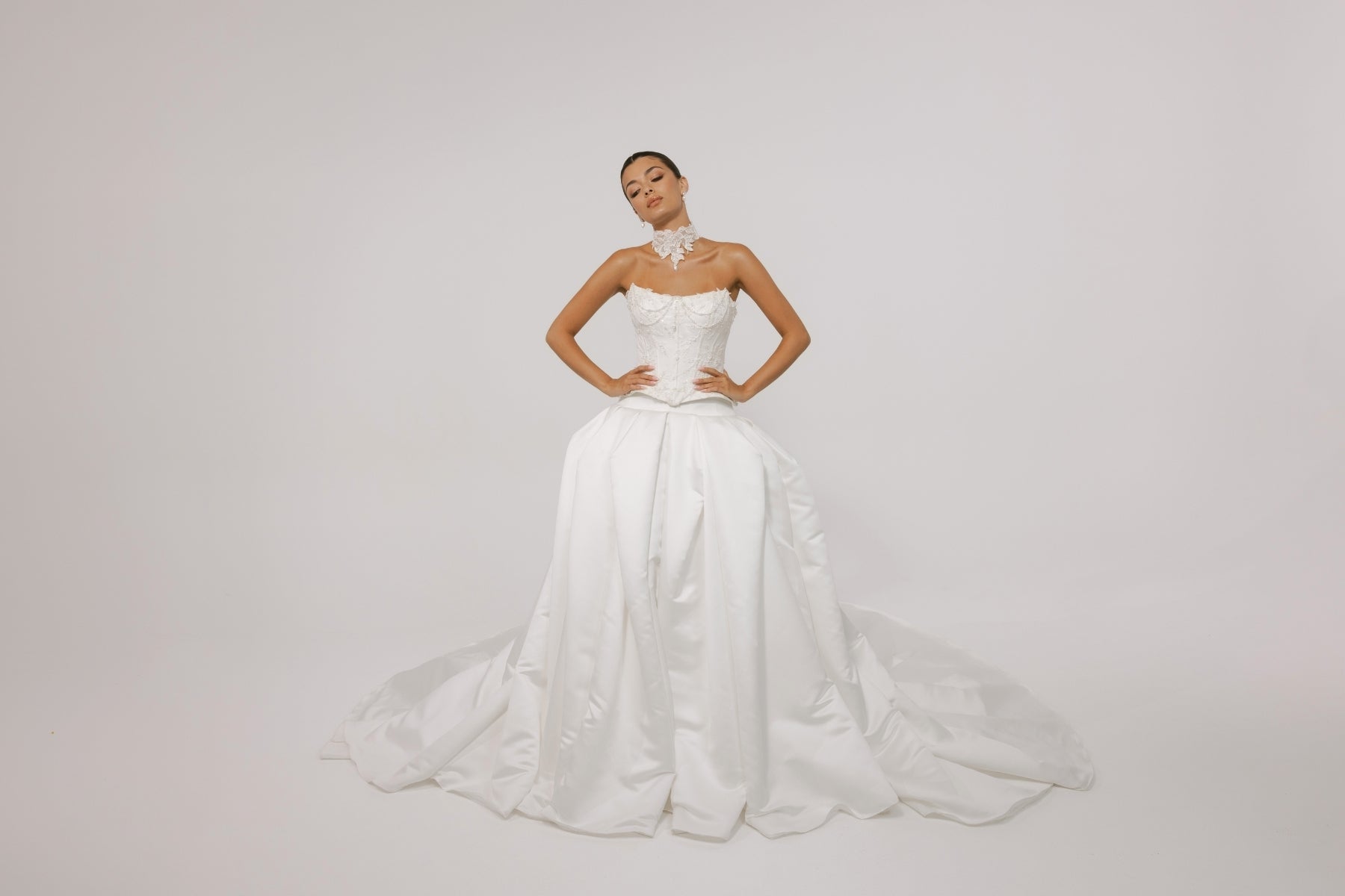 two-piece wedding gown, elaborate corset with hip panels, draped in pearls. paired with a high fashion pleated mikado skirt 