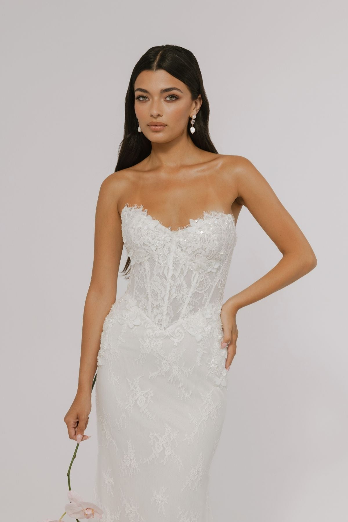 sweetheart neckline fitted wedding gown featuring basque waist and corset boning, with floral lace. 