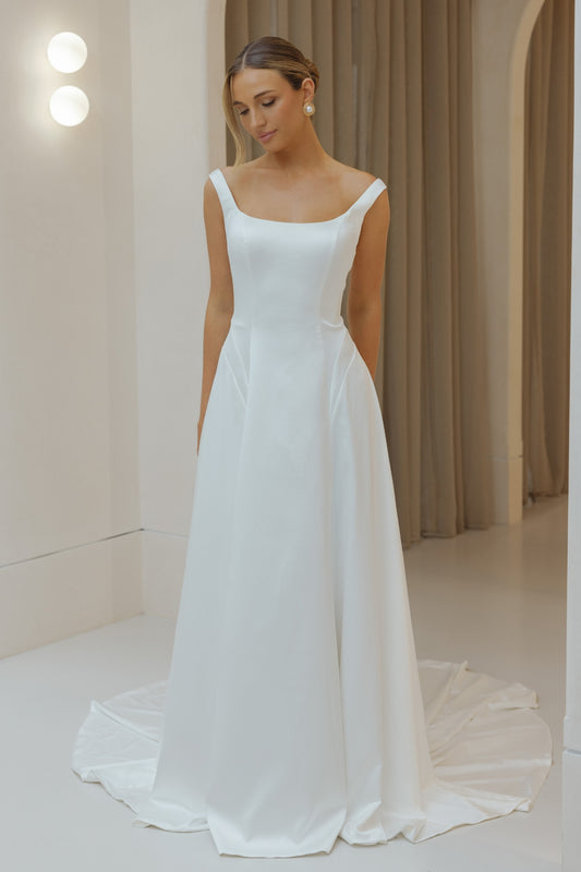Satin A-line sheath wedding gown with square neckline and straps. 