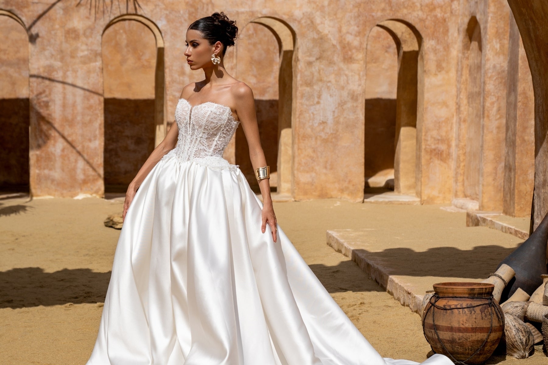 A-line wedding gown with lace bodice and plain skirt featuring basque waistline 