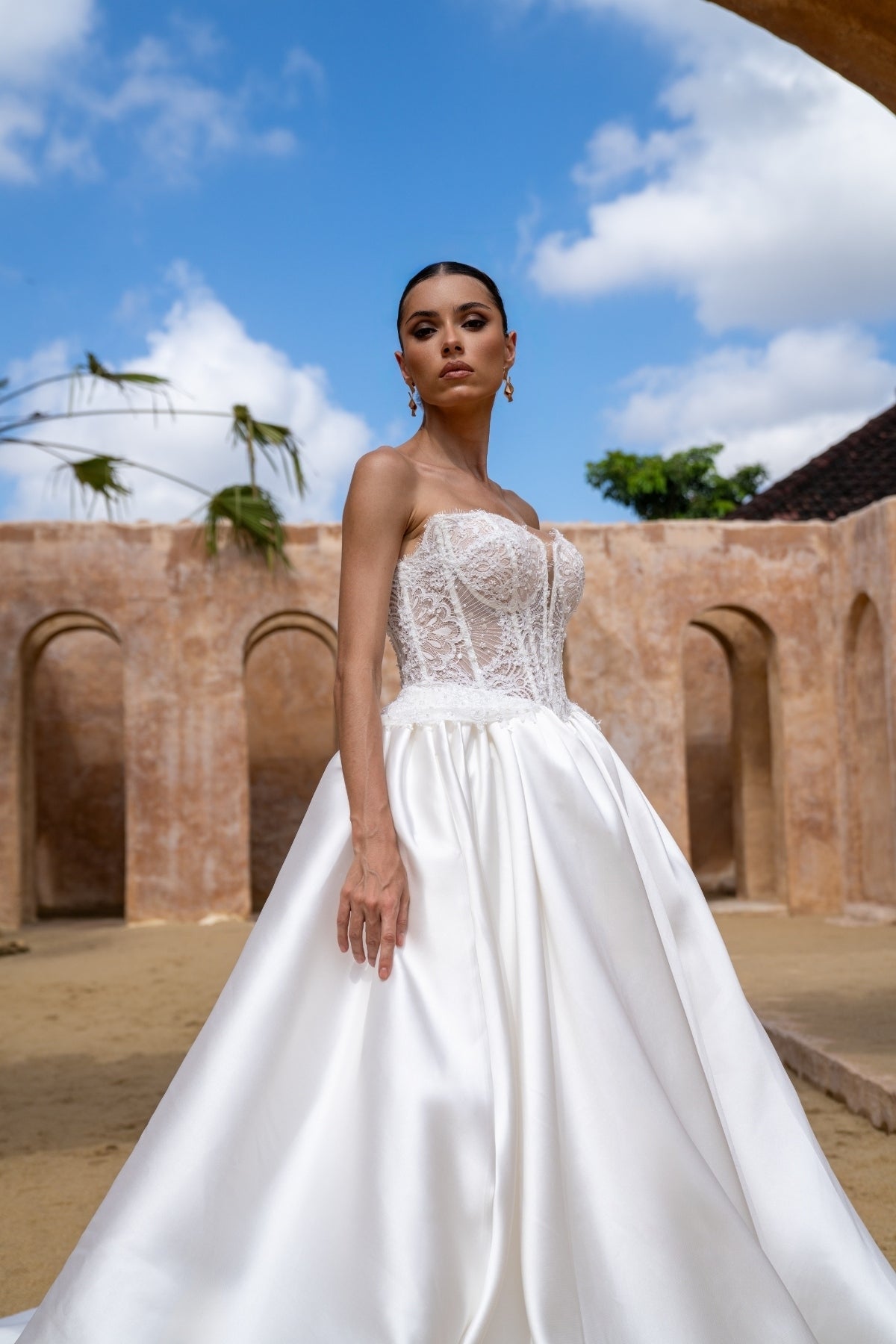 A-line wedding gown with lace bodice and plain skirt featuring basque waistline 