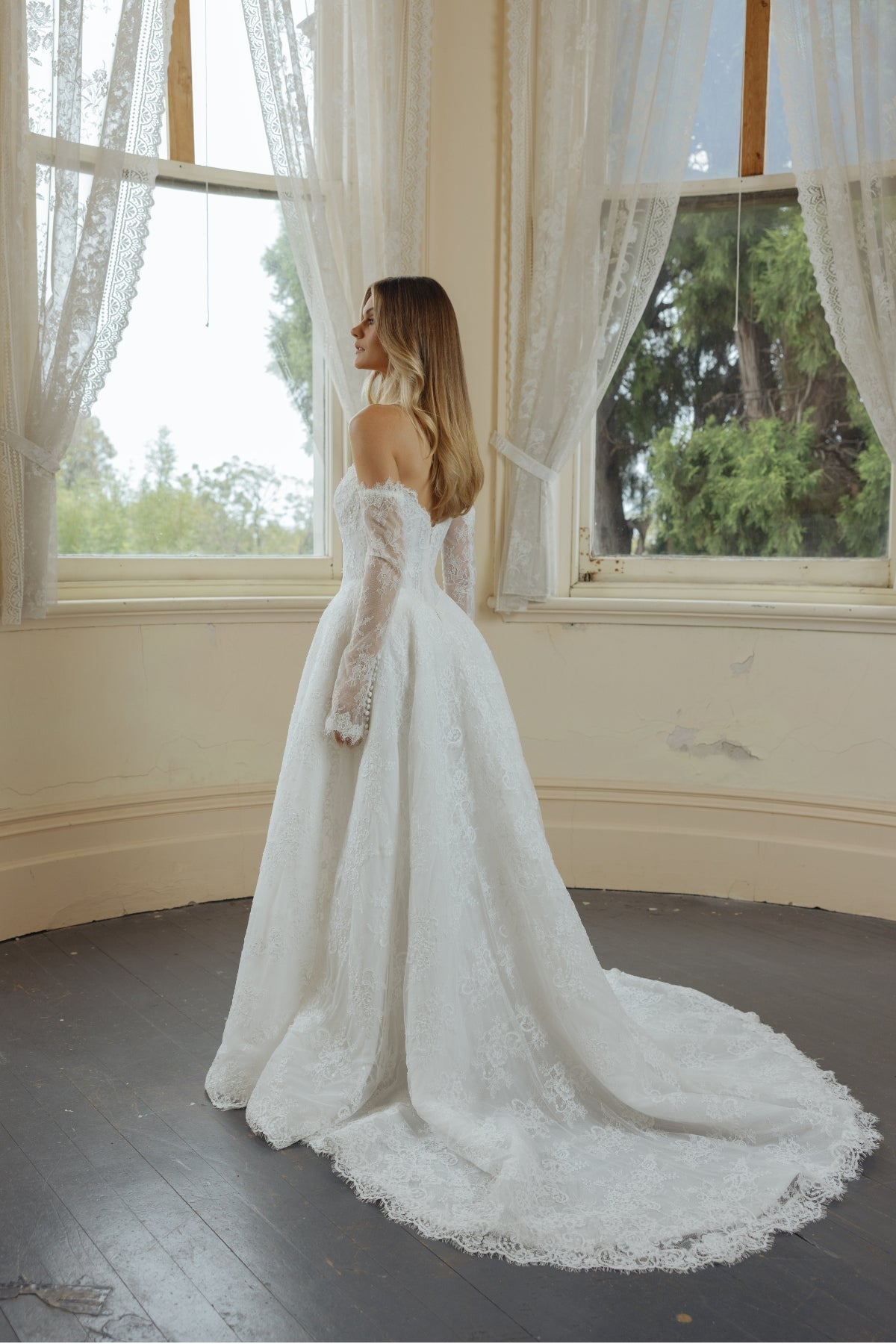 A-line wedding dress in lace, featuring a sweetheart neckline and steep basque waist, full of volume and drama. fitted lace sleeves included 