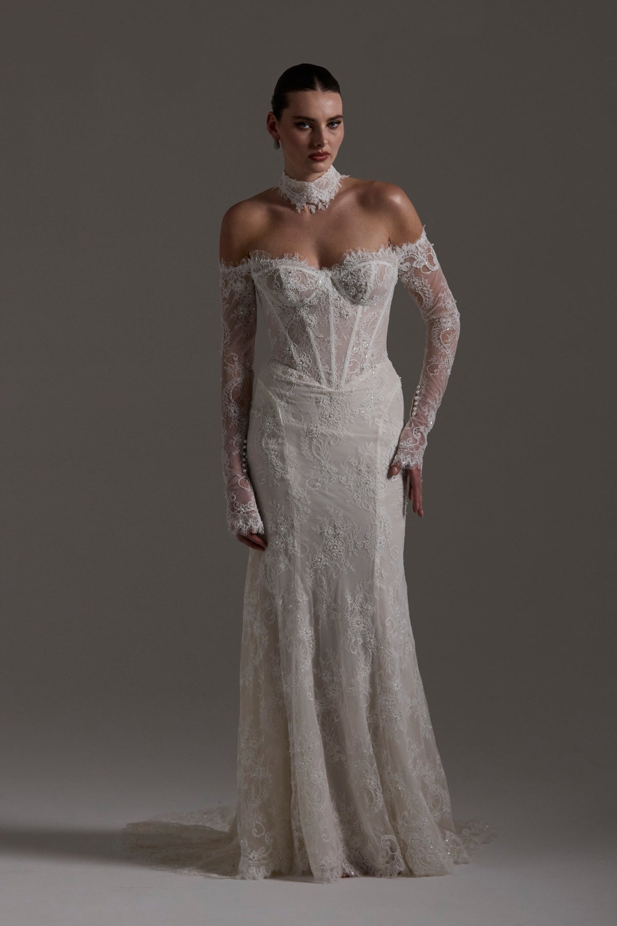 Fitted wedding gown featuring off-the-shoulder sleeves and neckline, vintage chantilly lace, basque waist, and lace choker. 