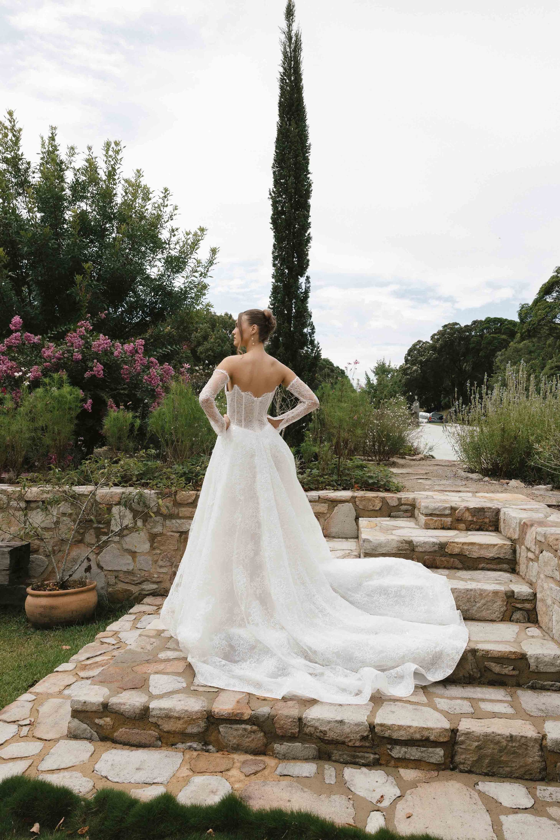 Caitlyn Gown – A-line lace bridal dress with a chapel train, matching lace gloves, and a V-plunge by Roselle collection Jessica Couture
