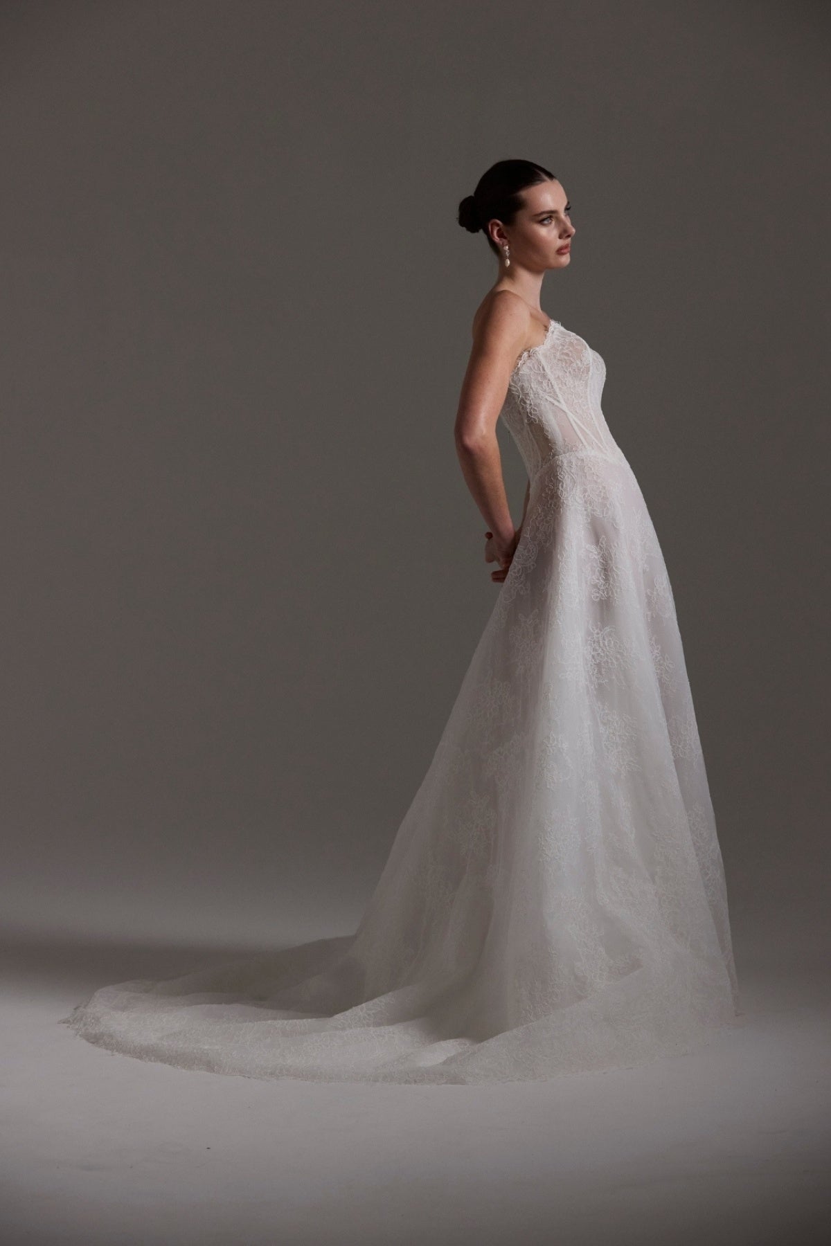 lace A-line wedding dress featuring a strapless neckline, exposed corset boning and unique waistline