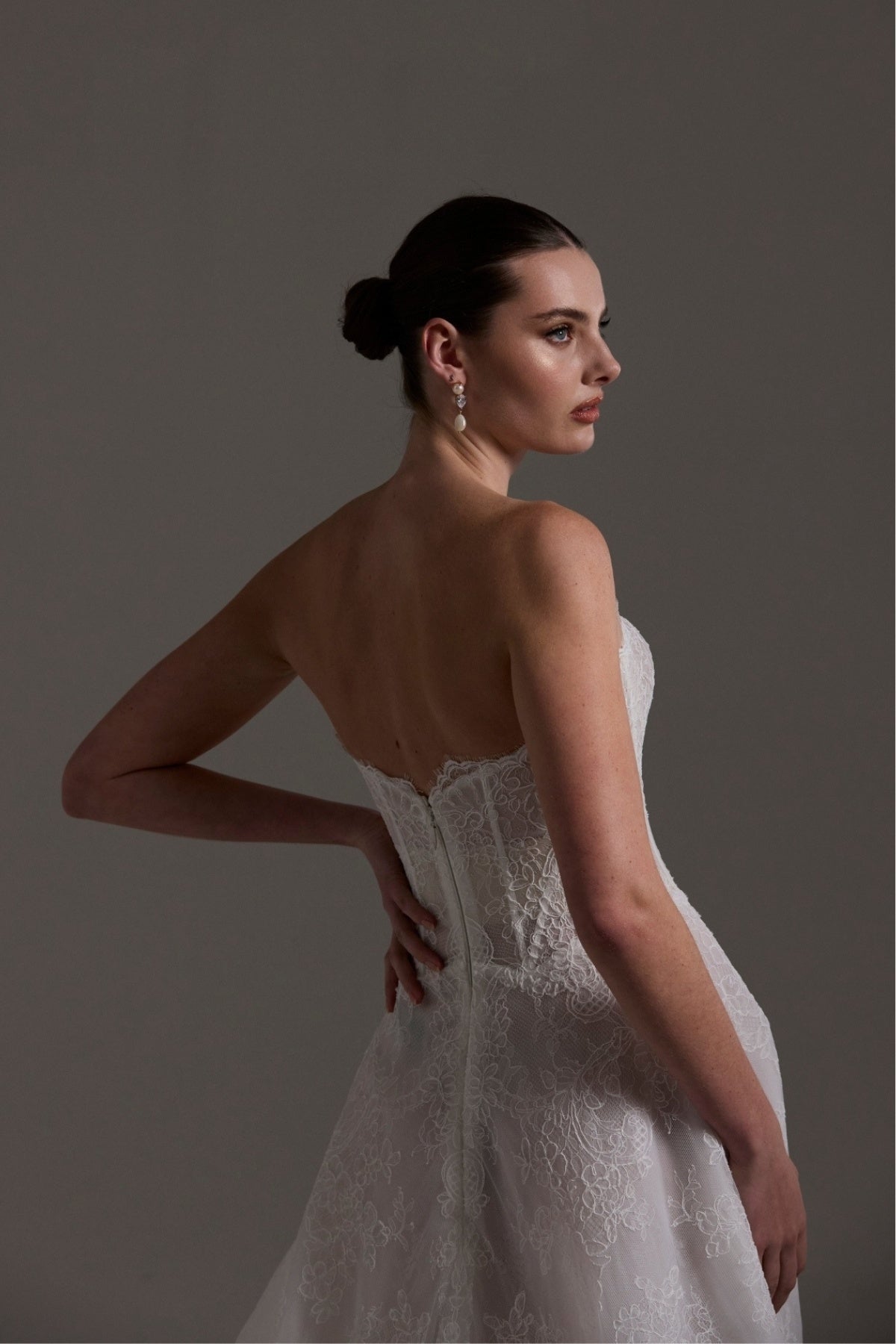 lace A-line wedding dress featuring a strapless neckline, exposed corset boning and unique waistline