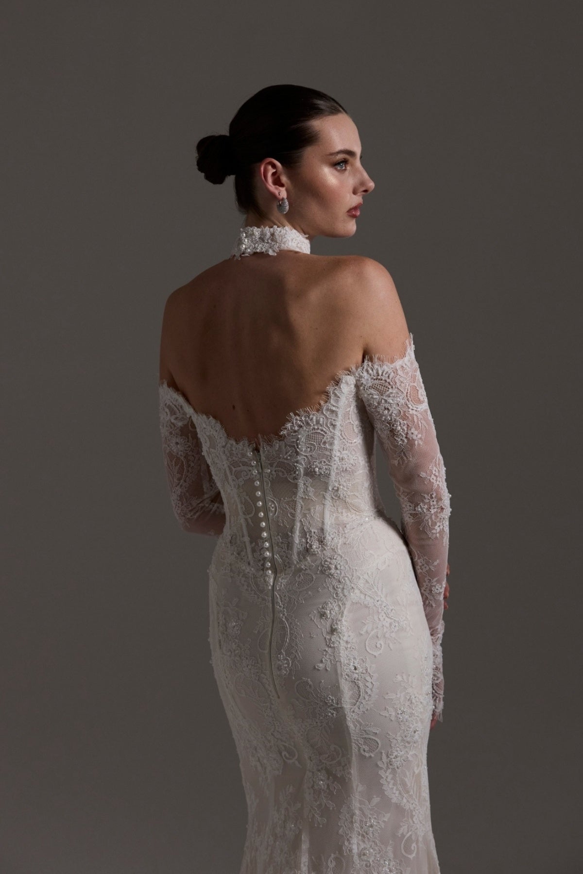 Fitted wedding gown featuring off-the-shoulder sleeves and neckline, vintage chantilly lace, basque waist, and lace choker. 