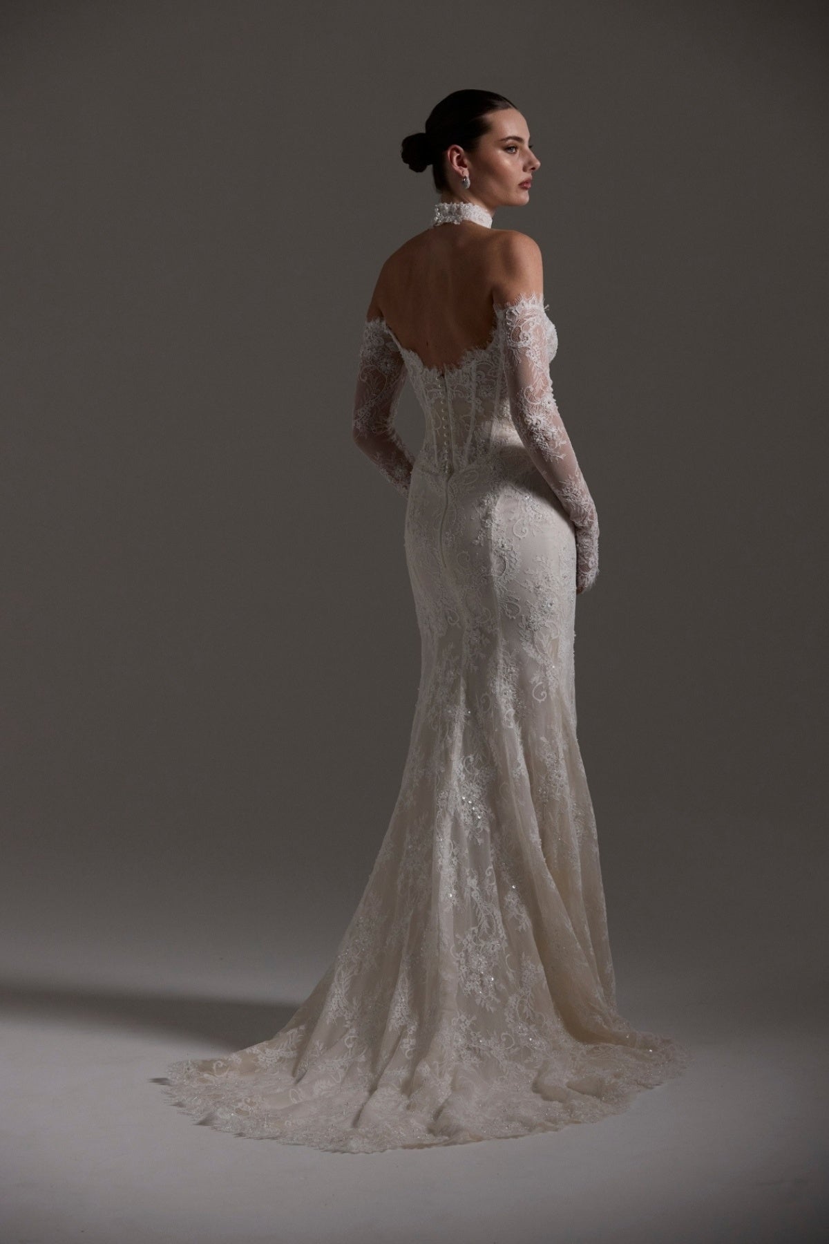 Fitted wedding gown featuring off-the-shoulder sleeves and neckline, vintage chantilly lace, basque waist, and lace choker. 