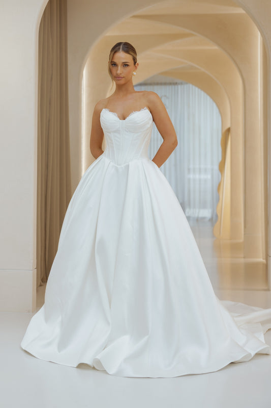 Mikado A-line dress, sweetheart neckline, basque waistline, voluminous skirt. 