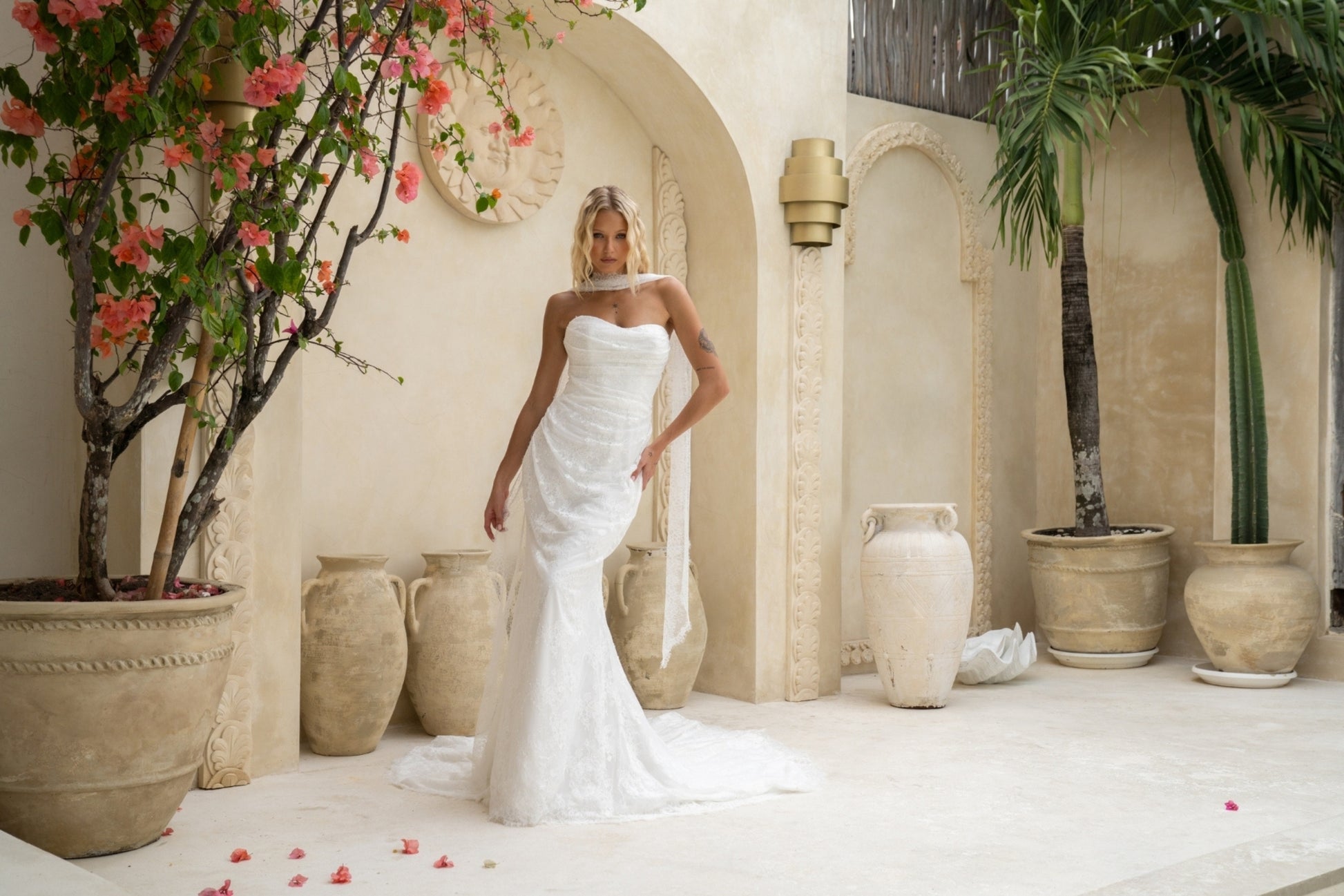 fitted lace wedding gown with sweetheart neckline, ruching across torso, paired with a lace scarf 