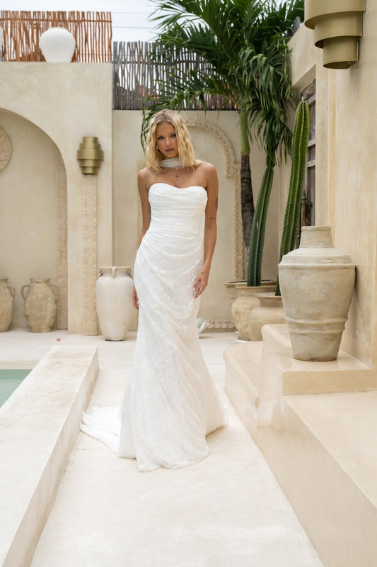 fitted lace wedding gown with sweetheart neckline, ruching across torso, paired with a lace scarf 