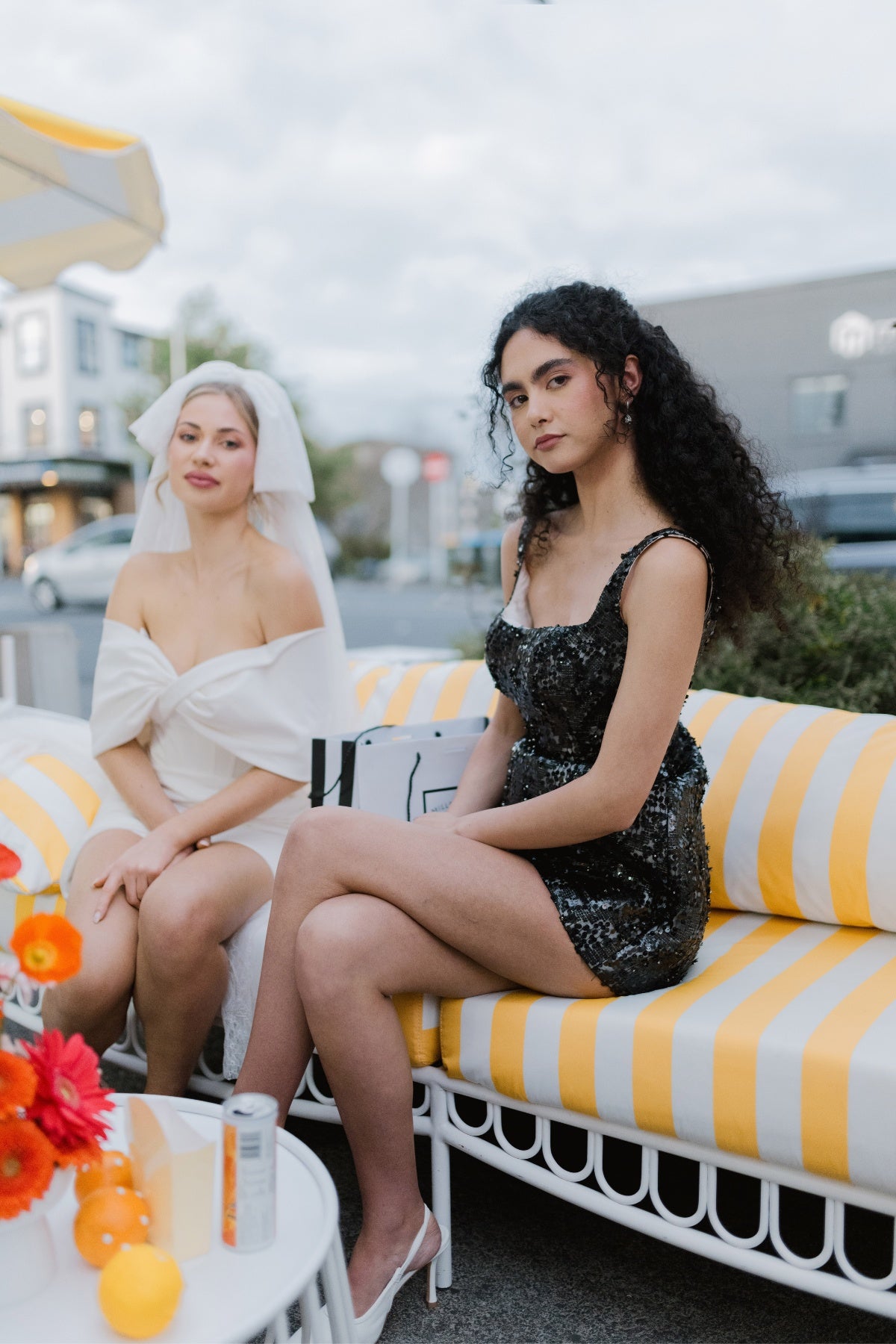 glittering black fitted mini dress with square neckline and straps. 
