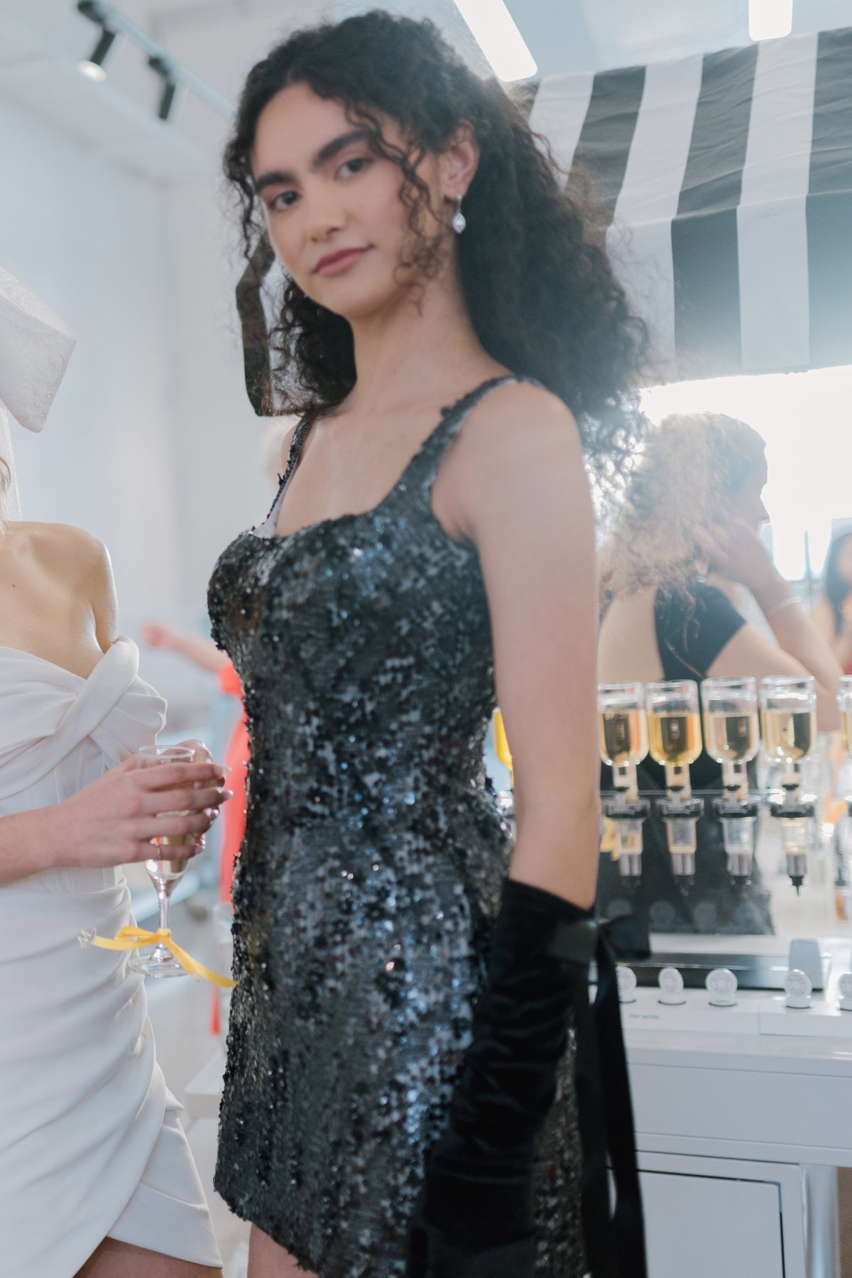 glittering black fitted mini dress with square neckline and straps. 