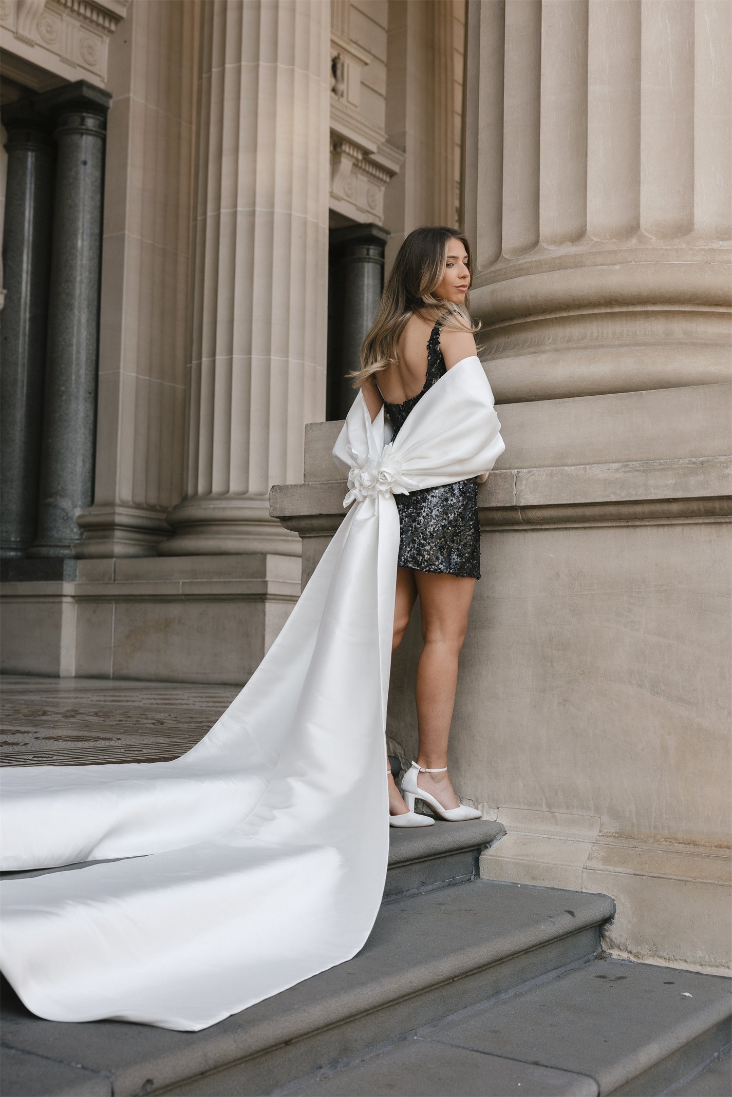glittering black fitted mini dress with square neckline and straps. 
