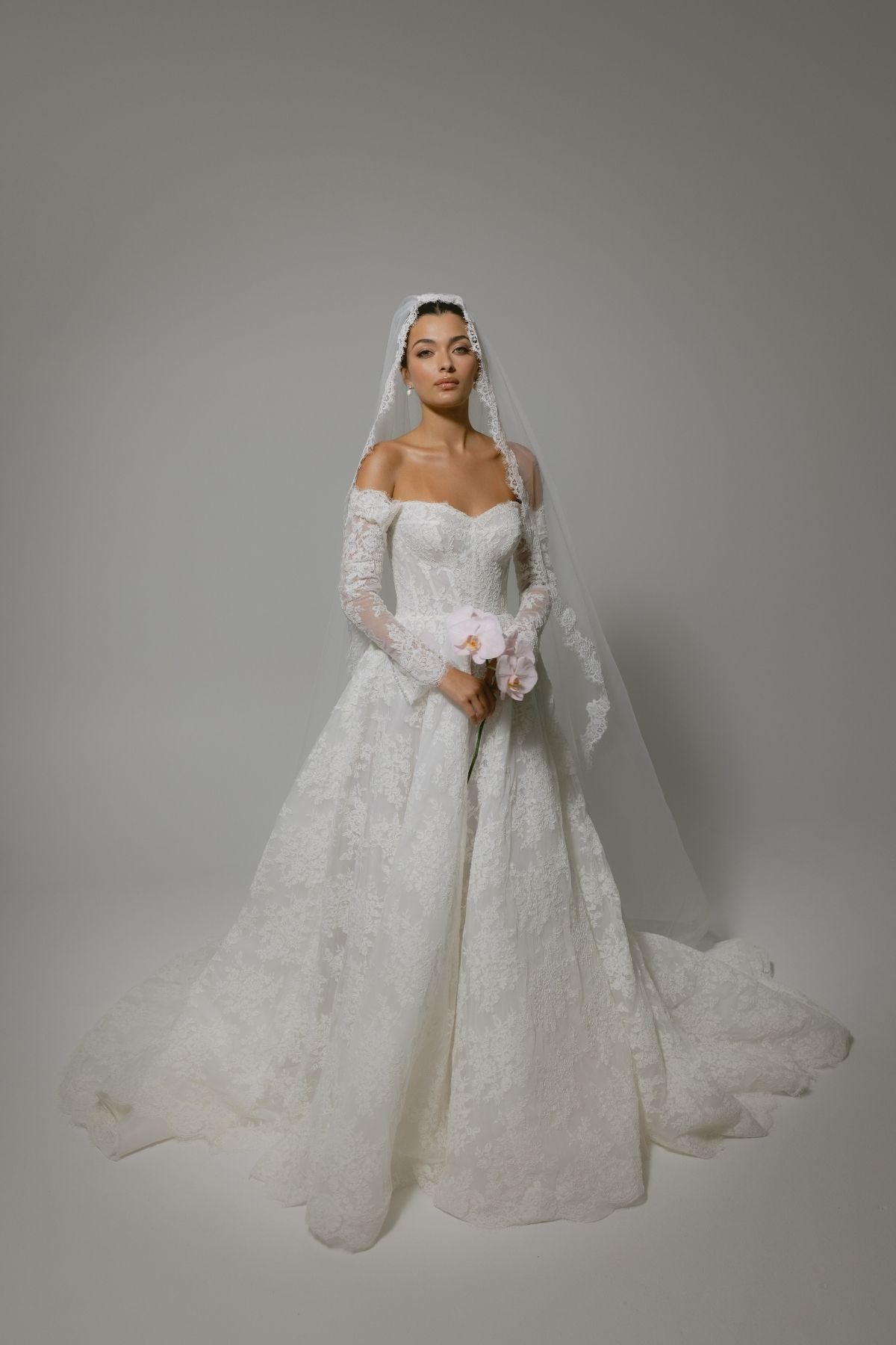 Lace A-line wedding gown with off the shoulder sleeves, dramatic chapel train 