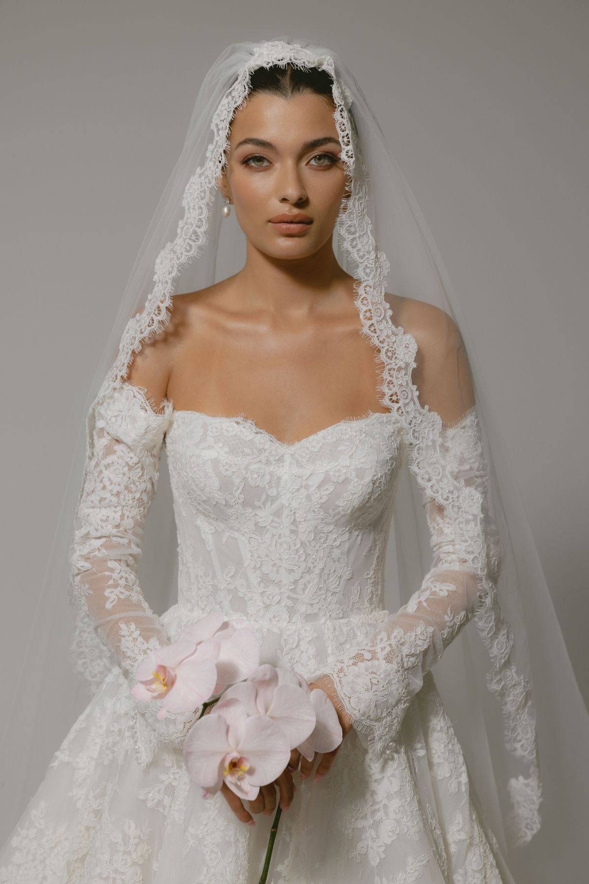 Lace A-line wedding gown with off the shoulder sleeves, dramatic chapel train 