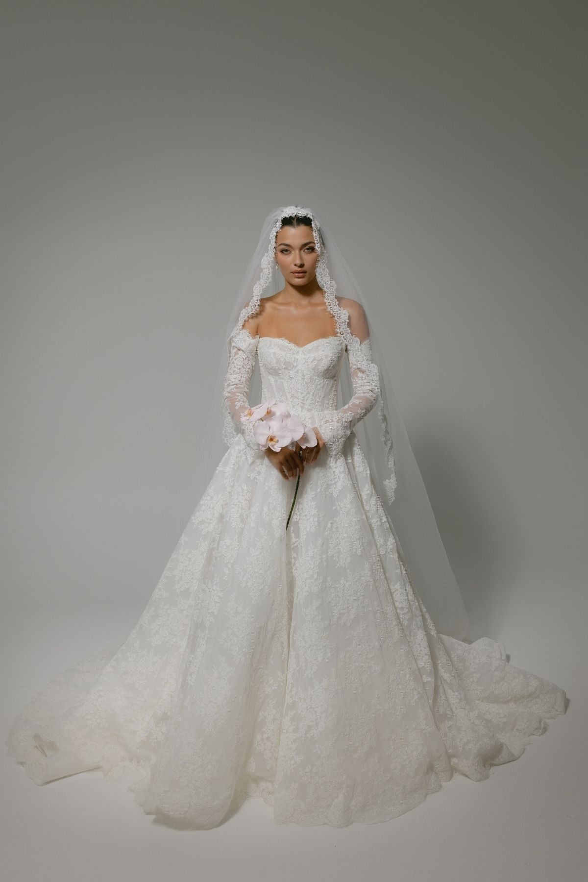 Lace A-line wedding gown with off the shoulder sleeves, dramatic chapel train 