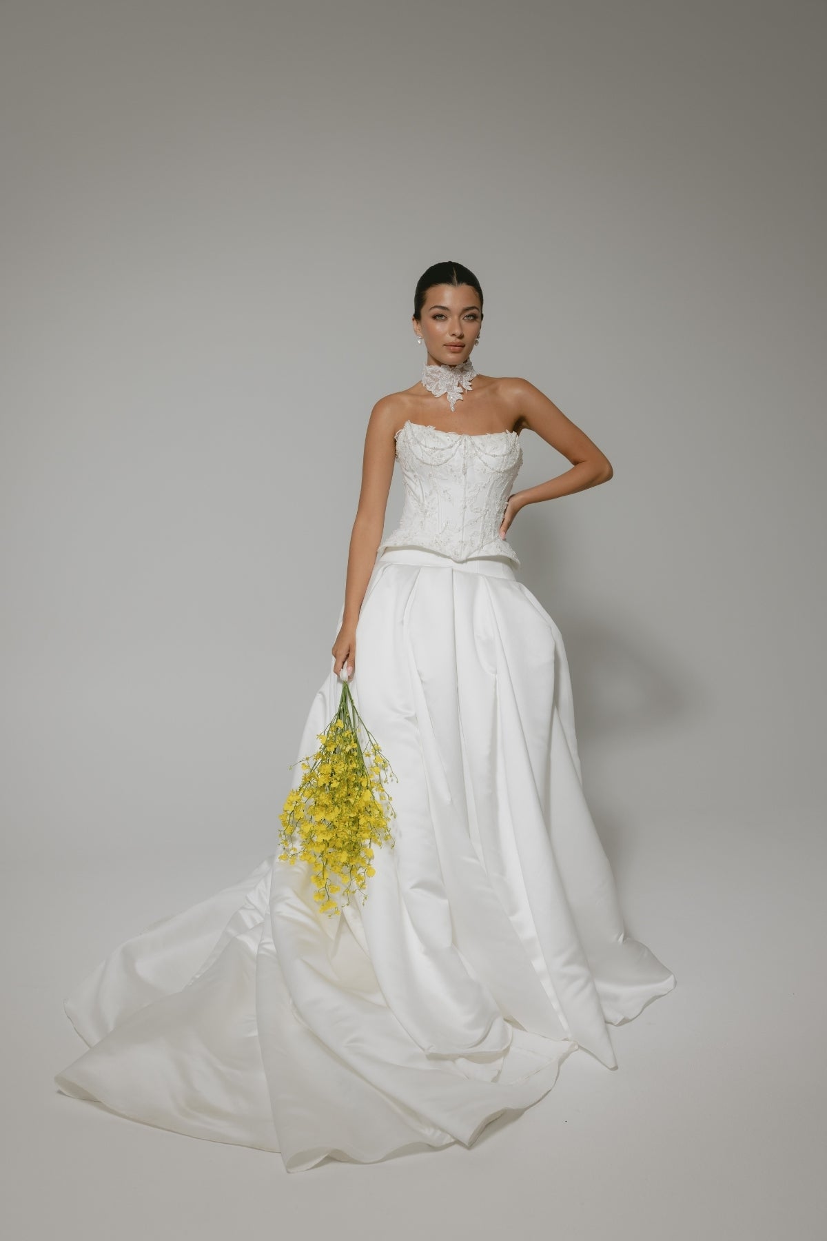 two-piece wedding gown, elaborate corset with hip panels, draped in pearls. paired with a high fashion pleated mikado skirt 