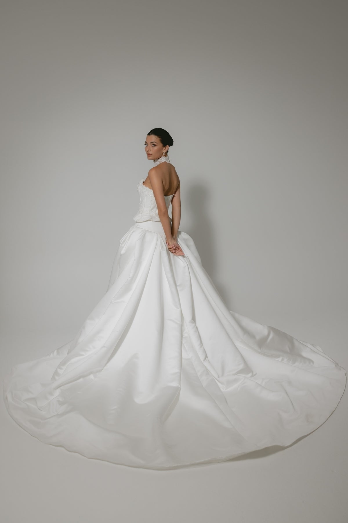 two-piece wedding gown, elaborate corset with hip panels, draped in pearls. paired with a high fashion pleated mikado skirt 
